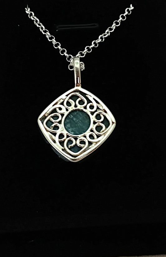 Silver pendant with Blue gemstone on a black background